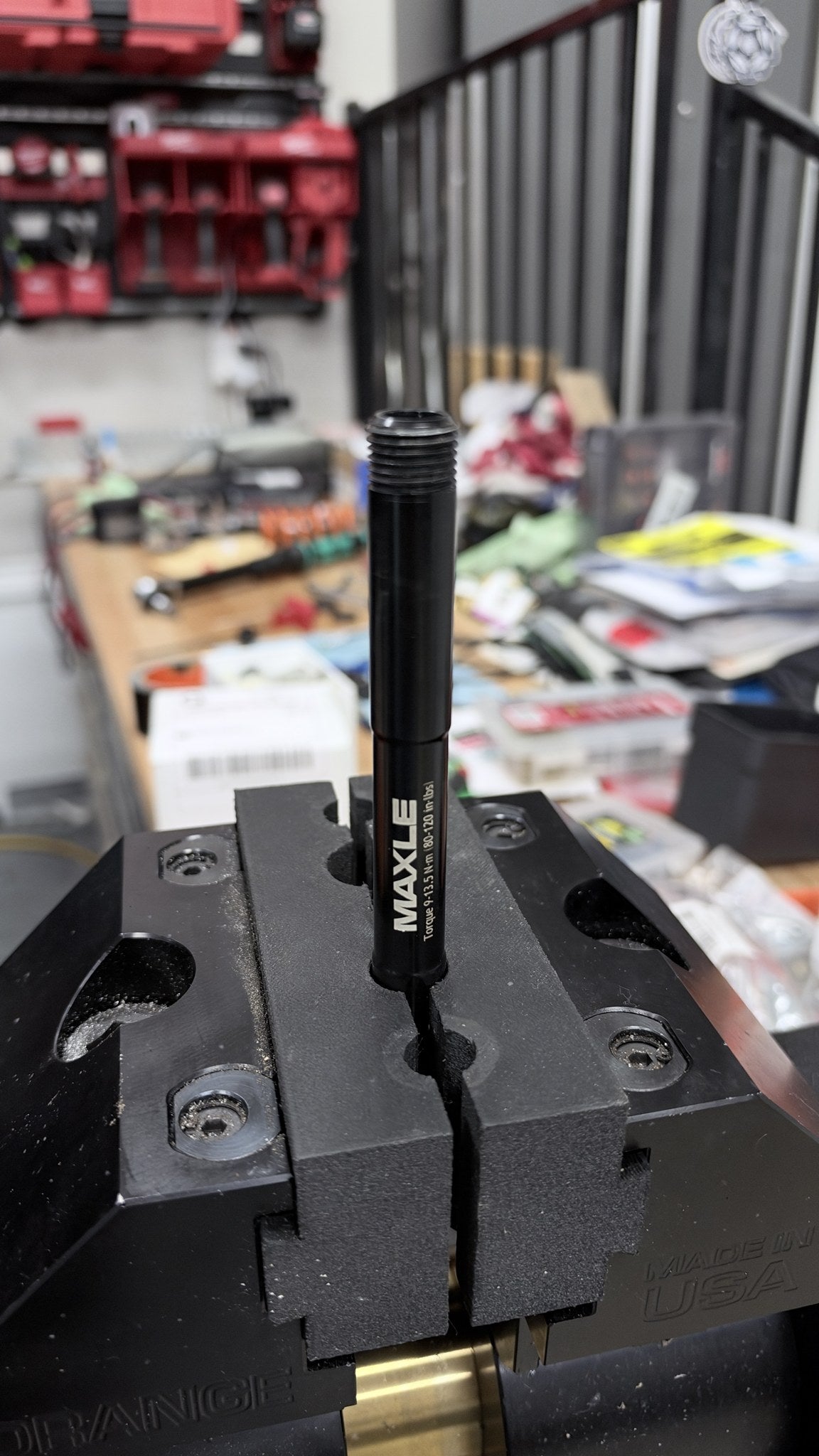 RockShox Maxle thru-axle clamped in the 15 mm groove of ZED0 soft jaws in an Orange bench vise